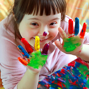 Girl with finger paint on her hands | SungateKids | Child Abuse Awareness, Support & Advocacy