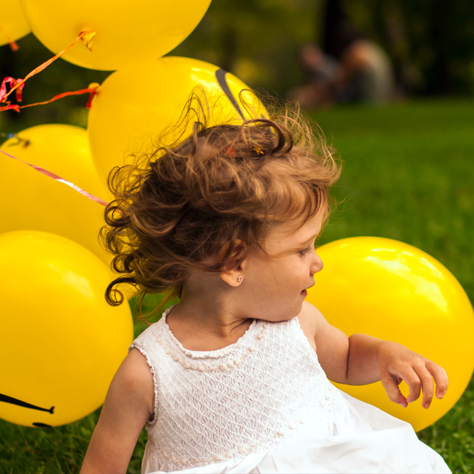 Young girl with yellow balloons | SungateKids | Child Abuse Awareness, Support & Advocacy