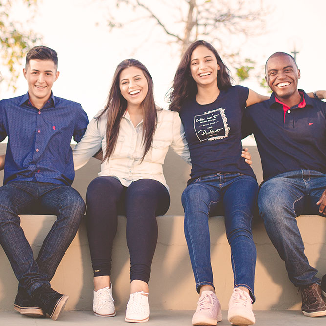 Group of teens, arms linked smiling at camera | SungateKids | Child Abuse Awareness, Support & Advocacy