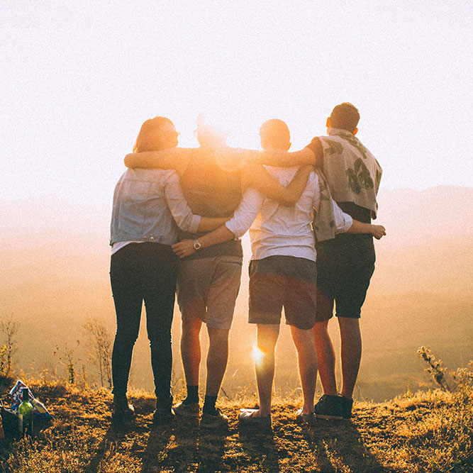 Group of people, embracing on a sunrise hike | SungateKids | Child Abuse Awareness, Support & Advocacy