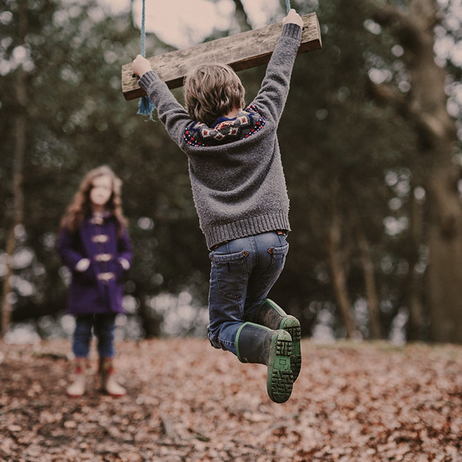 Boy & Girl playing in the fall leaves, playing on swing | SungateKids | Child Abuse Awareness, Support & Advocacy