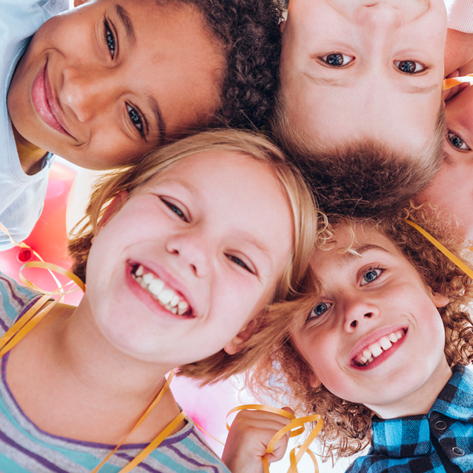 Group of kids, huddled together, smiling | SungateKids | Child Abuse Awareness, Support & Advocacy