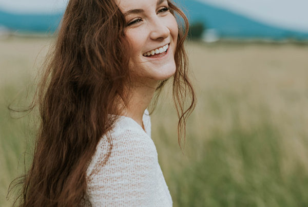 Teen girl, smiling in field of grass | SungateKids | Child Abuse Awareness, Support & Advocacy